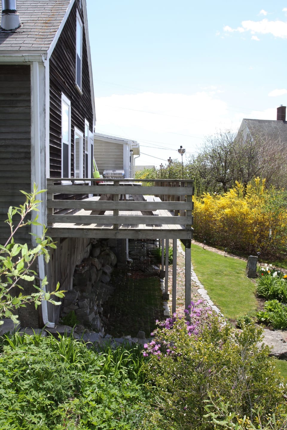 View of back deck. Complete with gas grill and dining table.