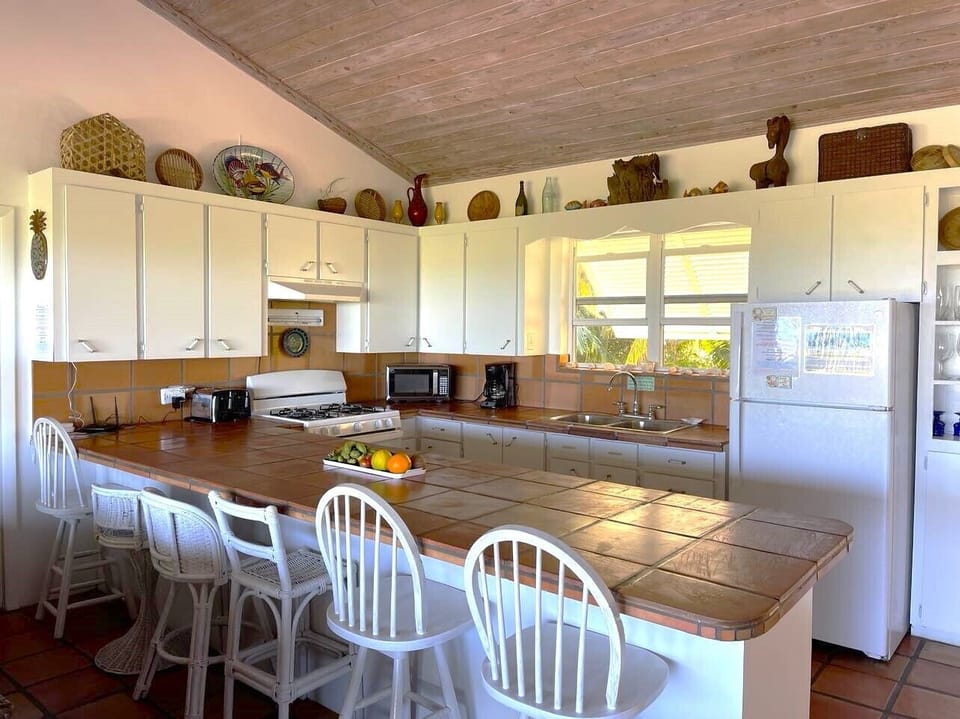 The fully equipped kitchen offers beautiful ocean views and seating for six 