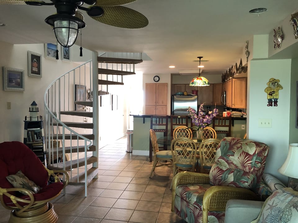 Open bright living room dining area with breakfast bar