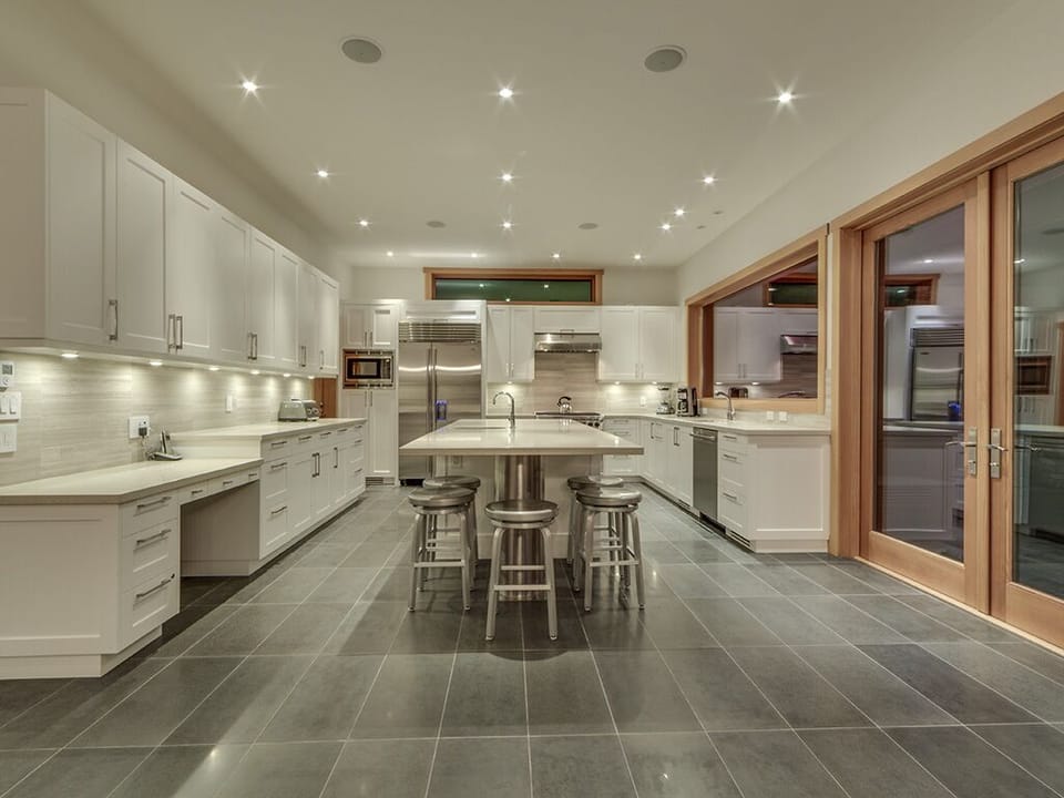 Beautiful large kitchen with centre island, stainless steel appliances and equipped with everything a chef would need to prepare a delicious meal