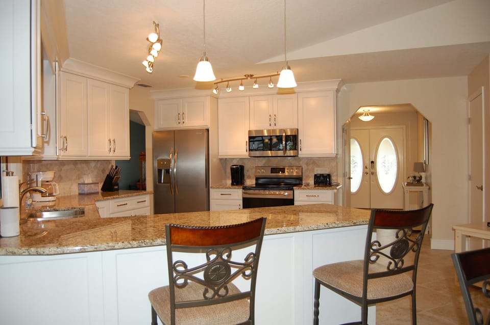 Kitchen w/ counter seating.  Granite countertops.