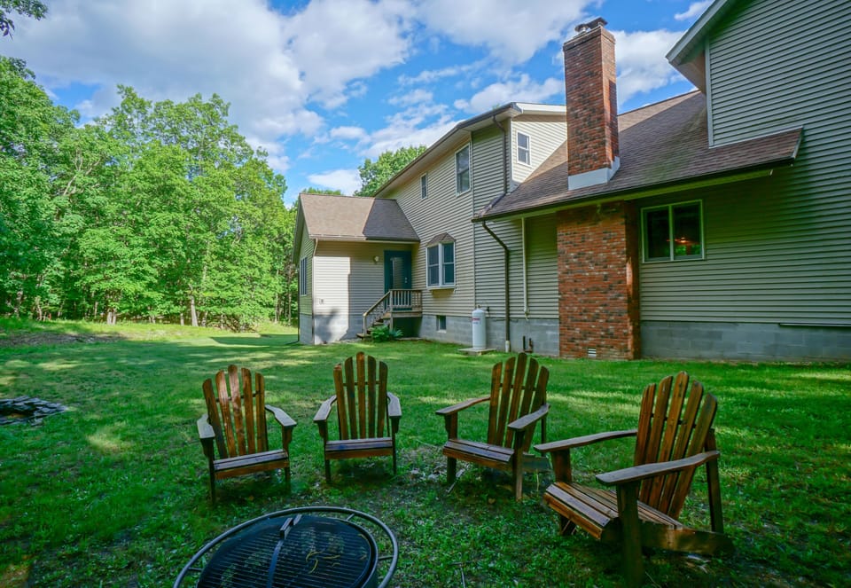 Relax by the firepit and enjoy the large backyard