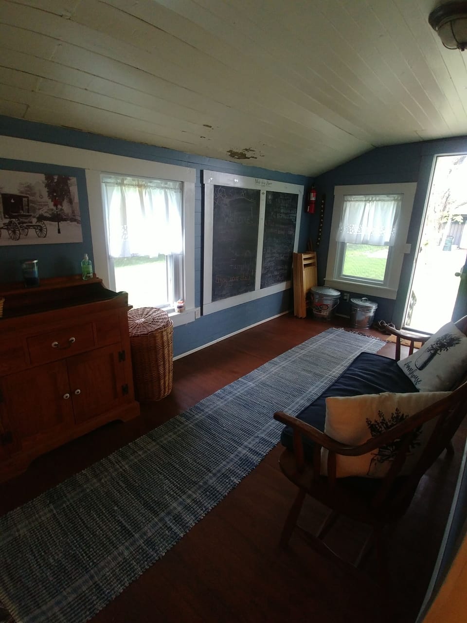 Mud room with coat racks and a place to sit a spell.