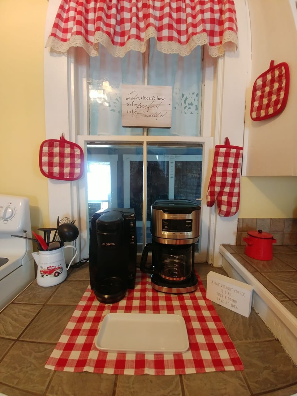 There is a large coffee pot and a Keurig.