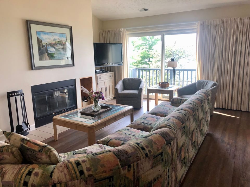Great room living area with doorwall to beach view