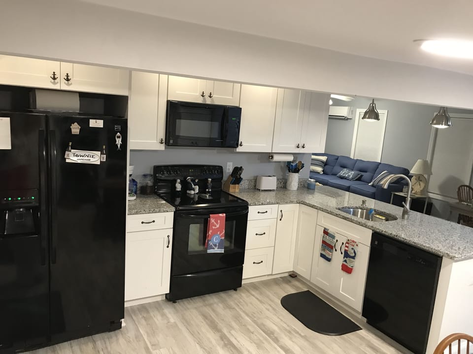 Kitchen w/electric stove, microwave, coffee maker, dishwasher,sink, toaster.
