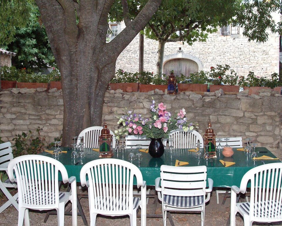 Courtyard dining table near barbecue.