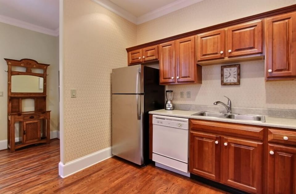 A large kitchen with utensils and cookware for you to prepare in house meals. 