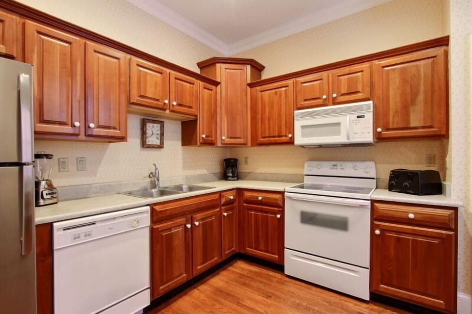 A large kitchen with utensils and cookware for you to prepare in house meals. 