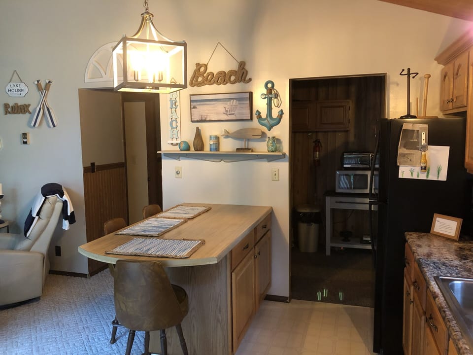 Hallway on left to Bathroom and bedrooms, entrance and dining room on right.