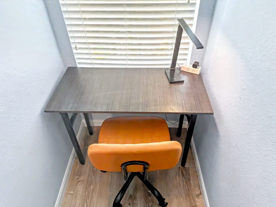 A workspace/desk is located in the alcove in the loft.   