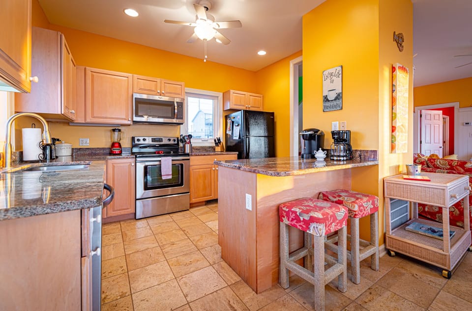 Kitchen: Coffee maker, Keurig, blender, and kitchen island for prepping.