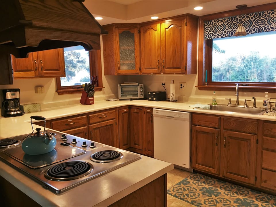 Kitchen with cooktop and griddle, stacked oven and microwave, large refrigerator