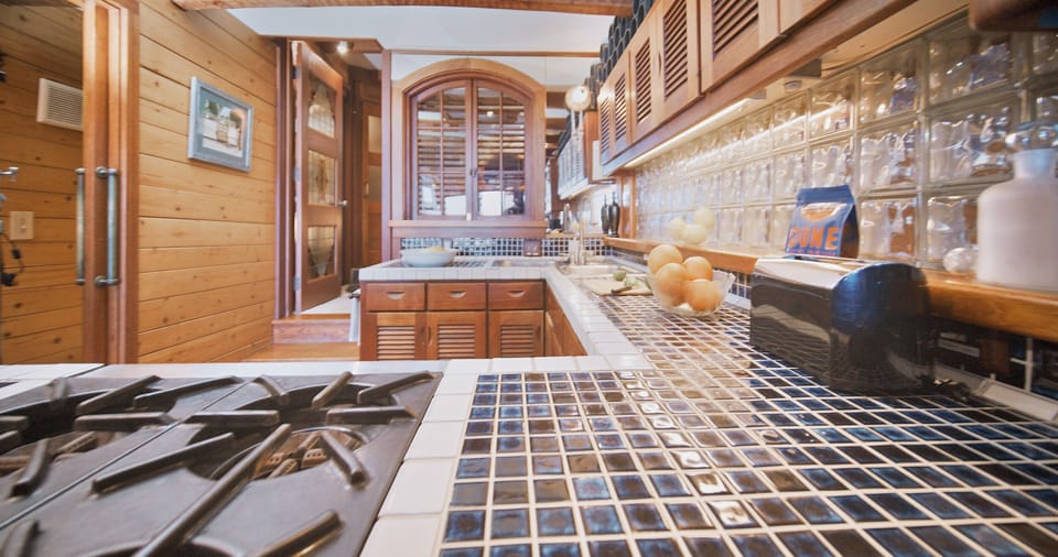 Kitchen stocked with basic appliances and amenities including coffee