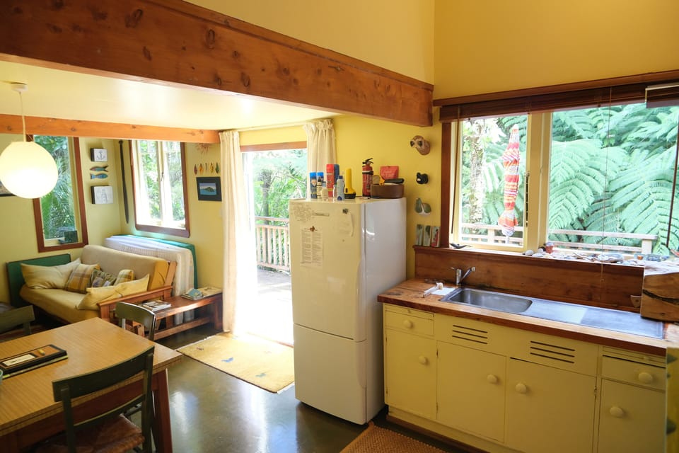 Downstairs kitchen, dinning and living room with French doors opening onto deck.