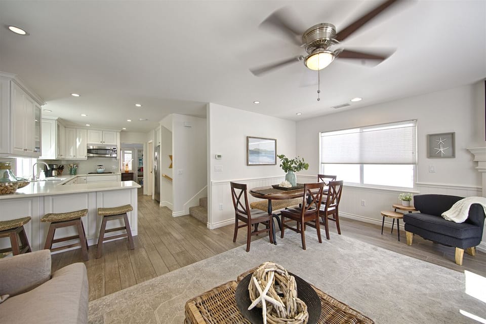 Comfortable main living room on 2nd floor, open to dining and modern kitchen, with multiple seating options