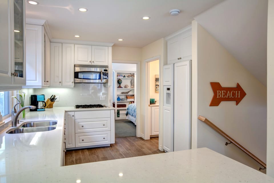 Open and bright kitchen with dining and living area just beyond