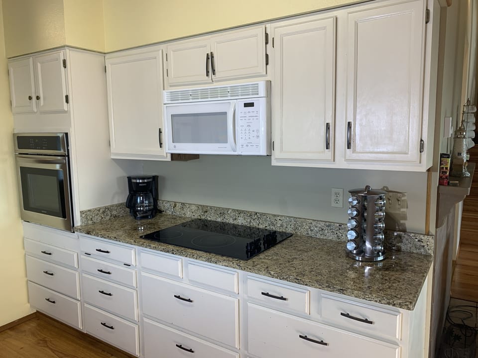 South side of the kitchen with stove, range, and microwave