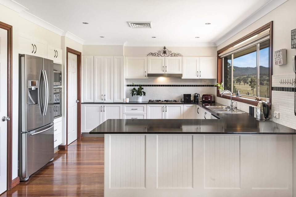Large kitchen with gas cooktop, fridge with icemaker, new oven and dishwasher.
