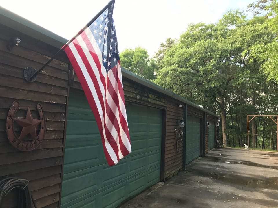 Hunters Cabin side view and concrete parking area. 