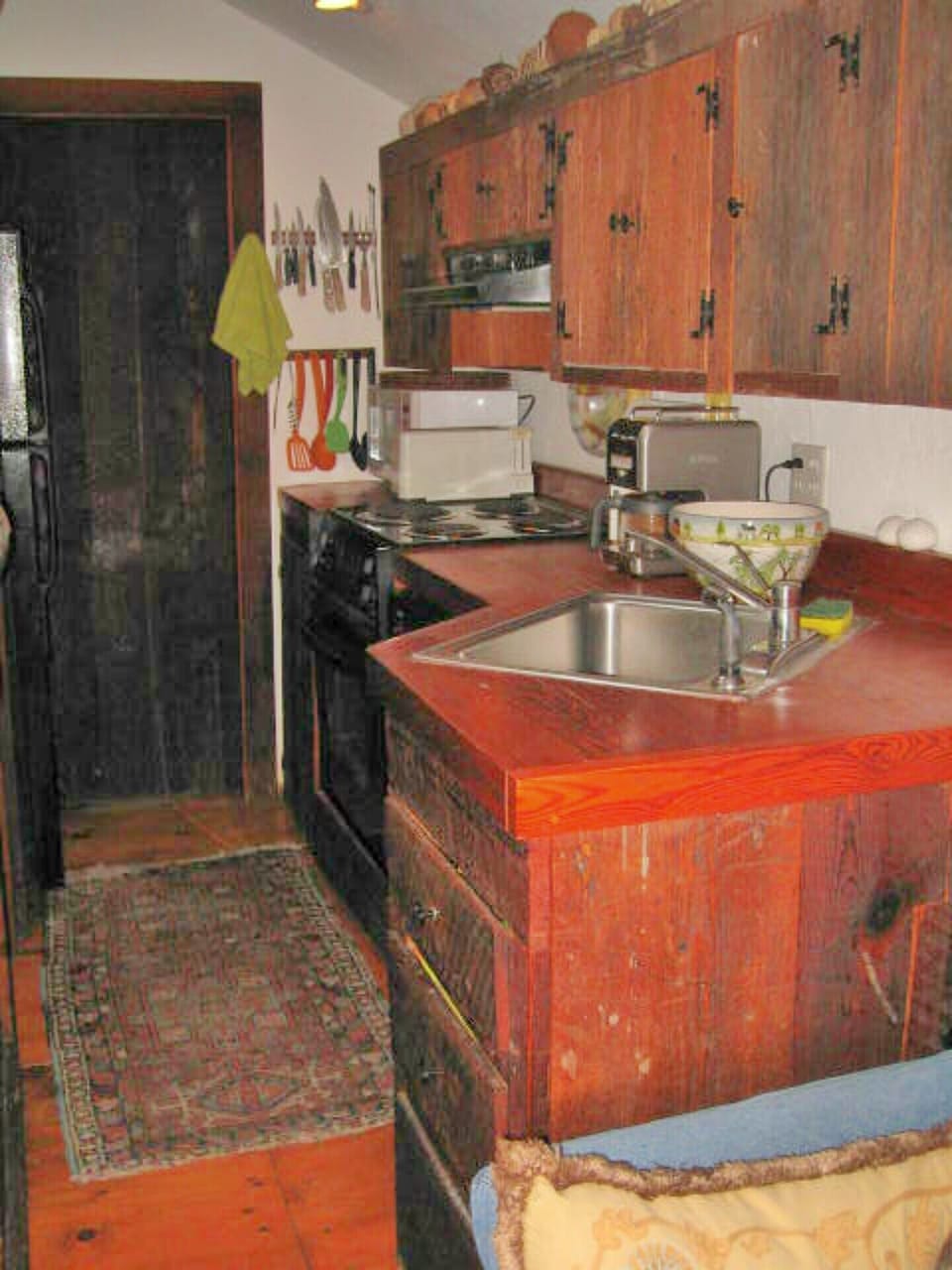 Galley kitchen with custom antique barn board cabinets