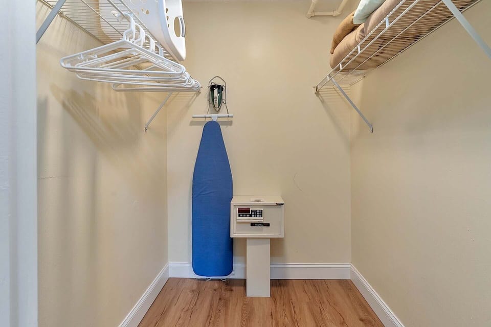 Bedroom closet with Ironing board and safe
