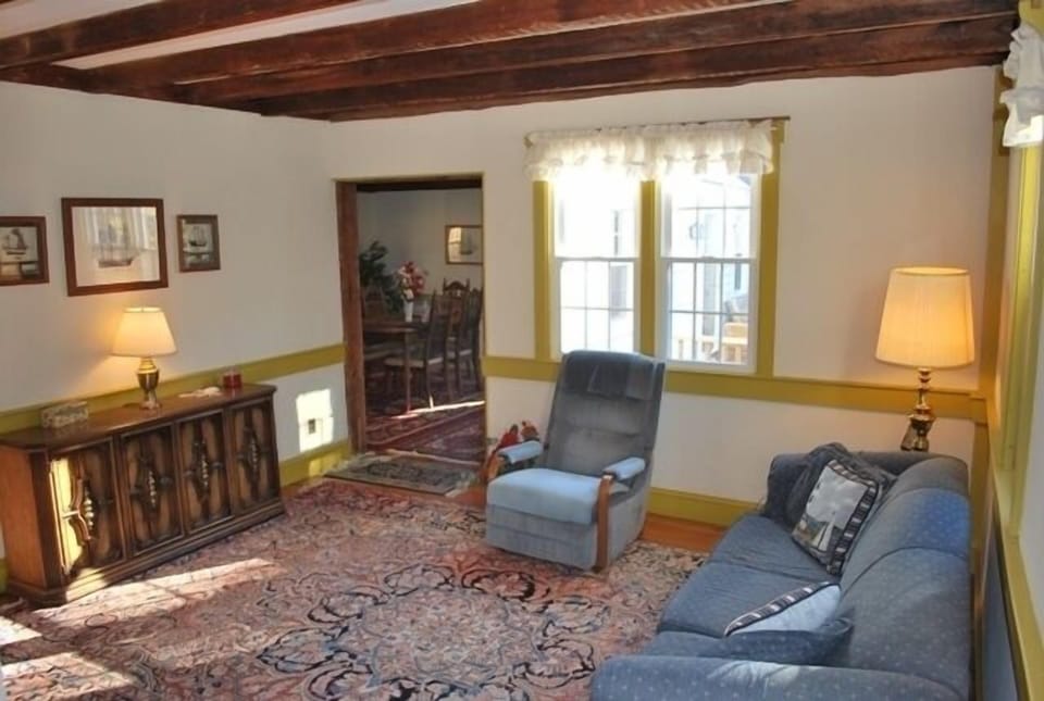 Living Room with exposed post and beams and wide pine floors