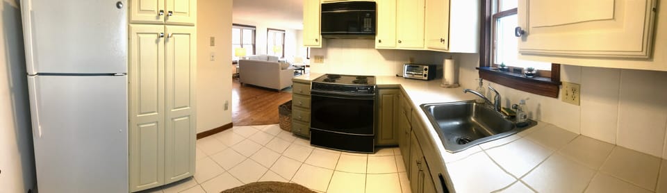 A view of the kitchen while looking toward the living room.
