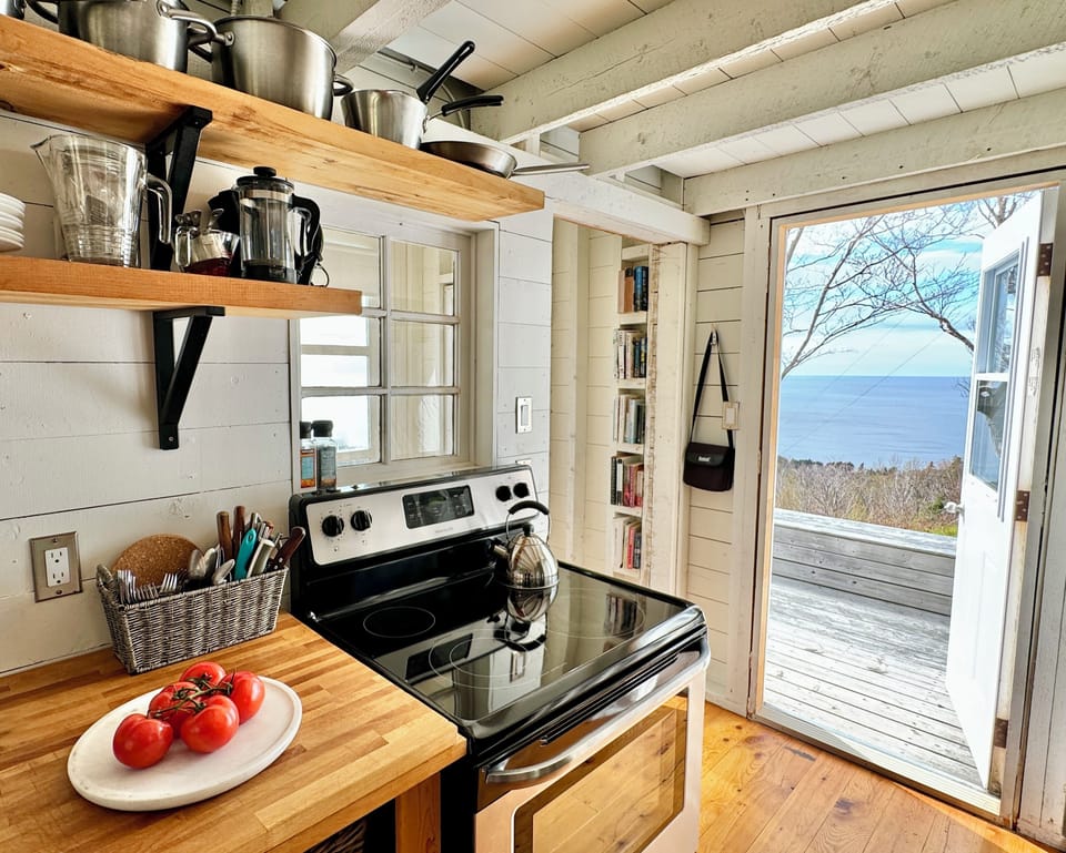 well-equipped kitchen, with views of ocean and beach from cooking / stove area