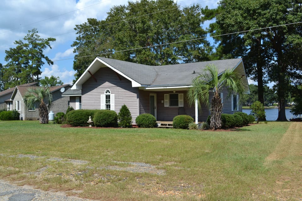 Street view, lake seen behind house