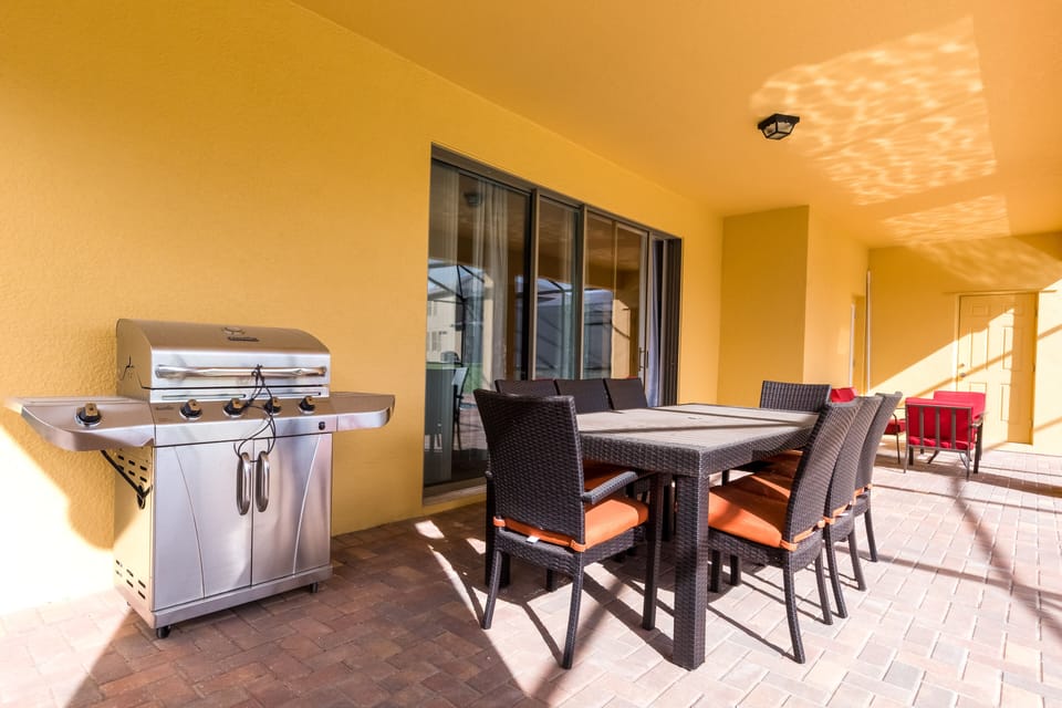 Patio table with 8 chairs and BBQ gas grill.