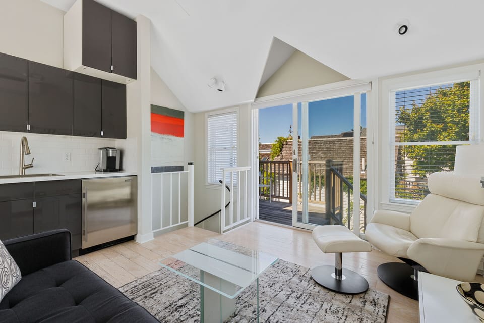 Clean and crisp, bright and airy upstairs living area with direct deck access