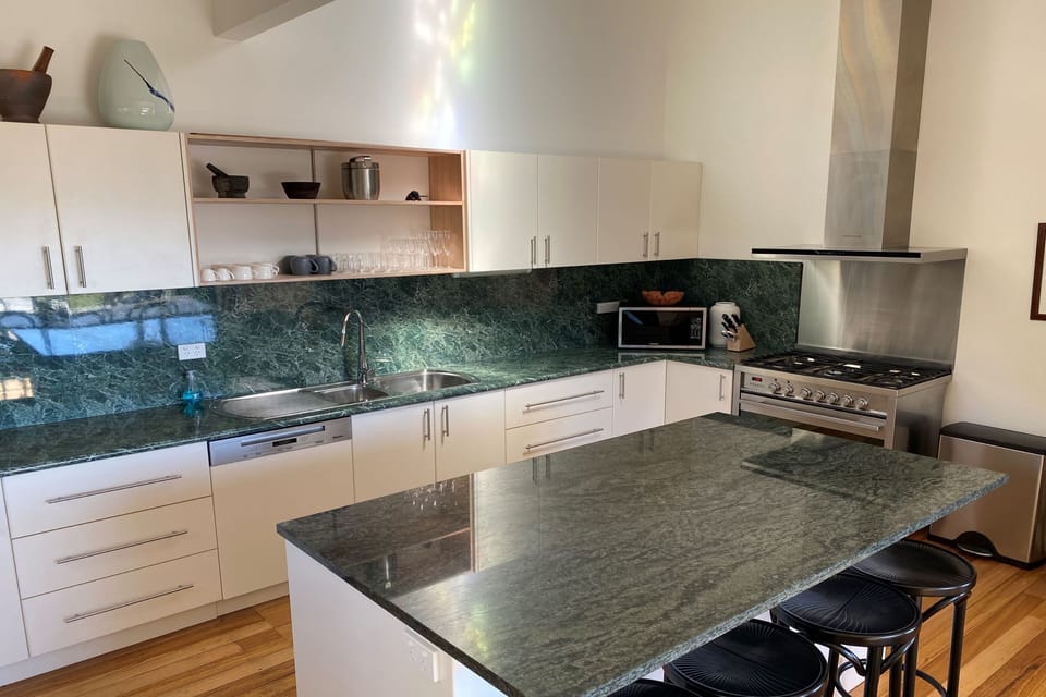 Huge kitchen, with large gas cooktop, and electric oven