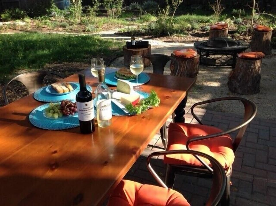 Dine alfresco at the big farm table, enjoy the fire pit and hot tub