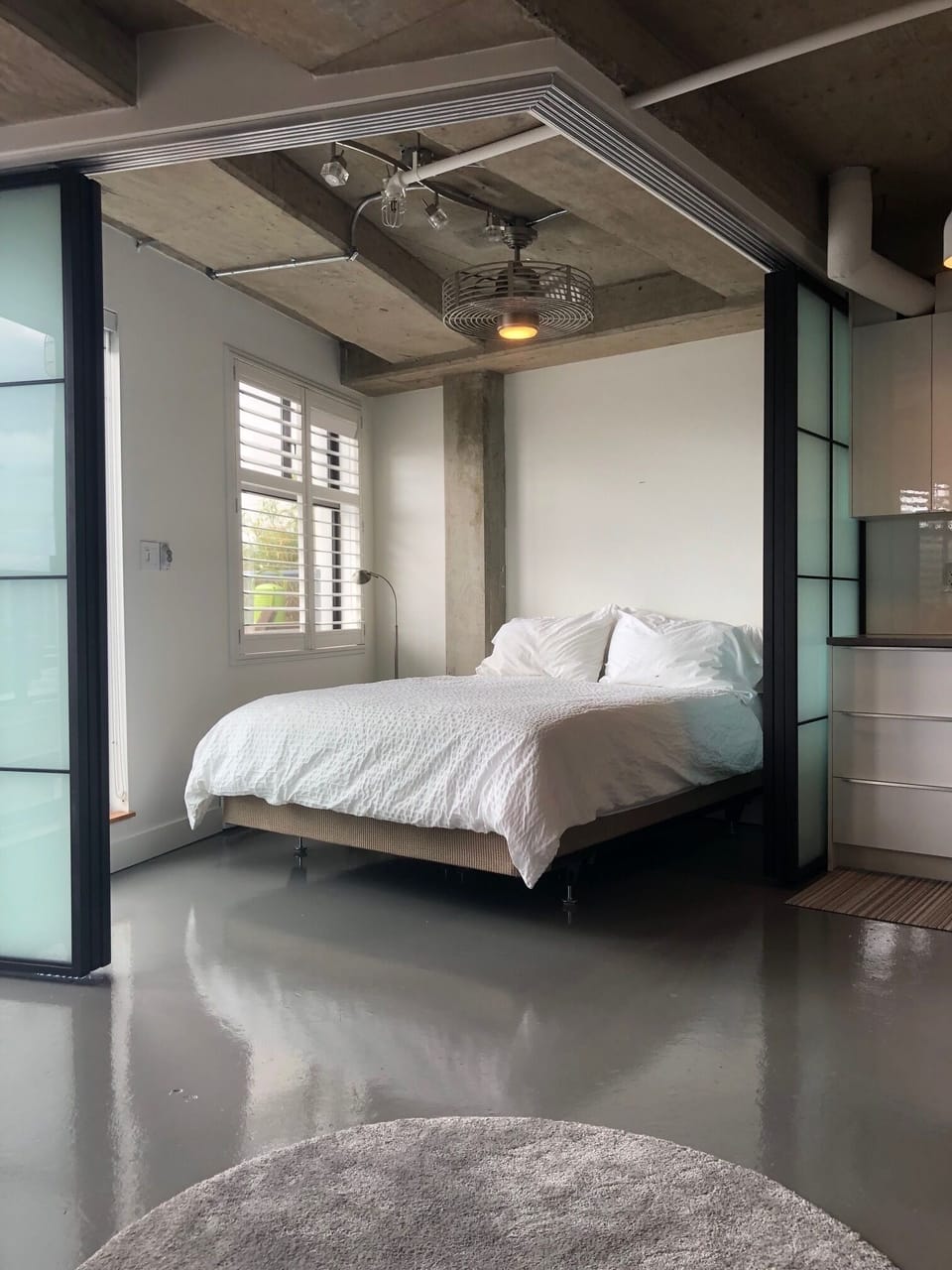 Open concept bedroom with glass sliders that give the ultimate in privacy.