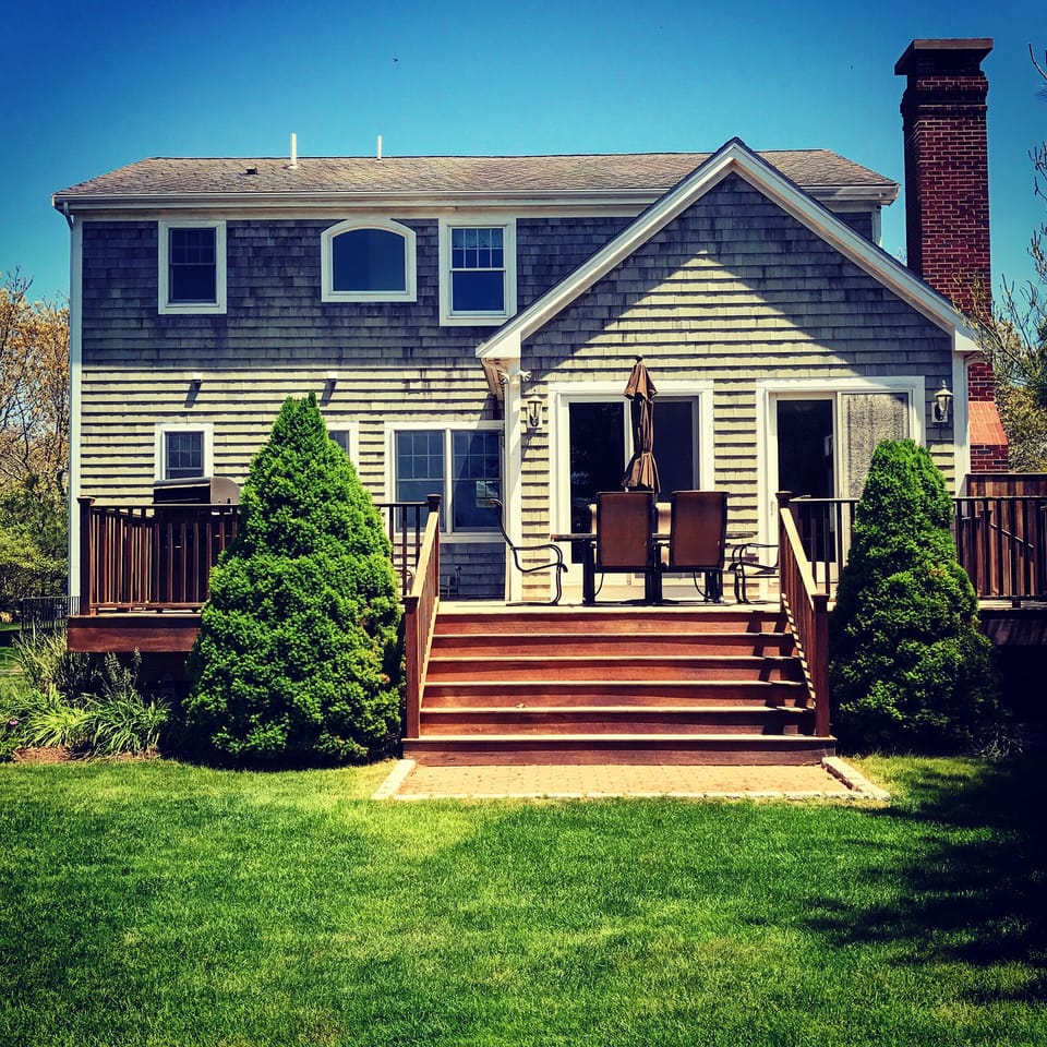 Spacious deck w/seating for 8 including to chaise lounge chairs and gas grill.