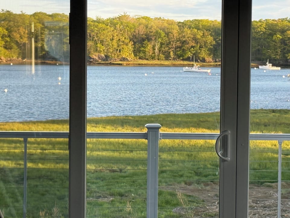  View from deck, living room, sunroom, dining room, and kitchen