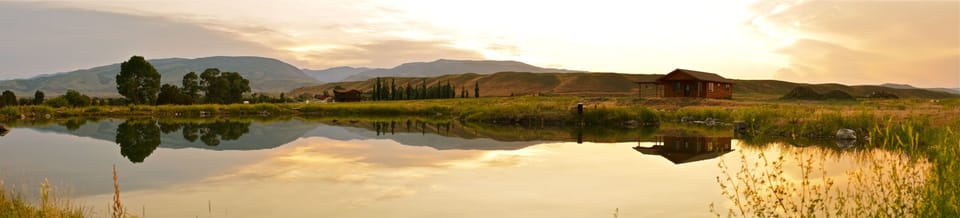 Panorama View of Wild Rose Cabin (pictured on the right) overlooking pond