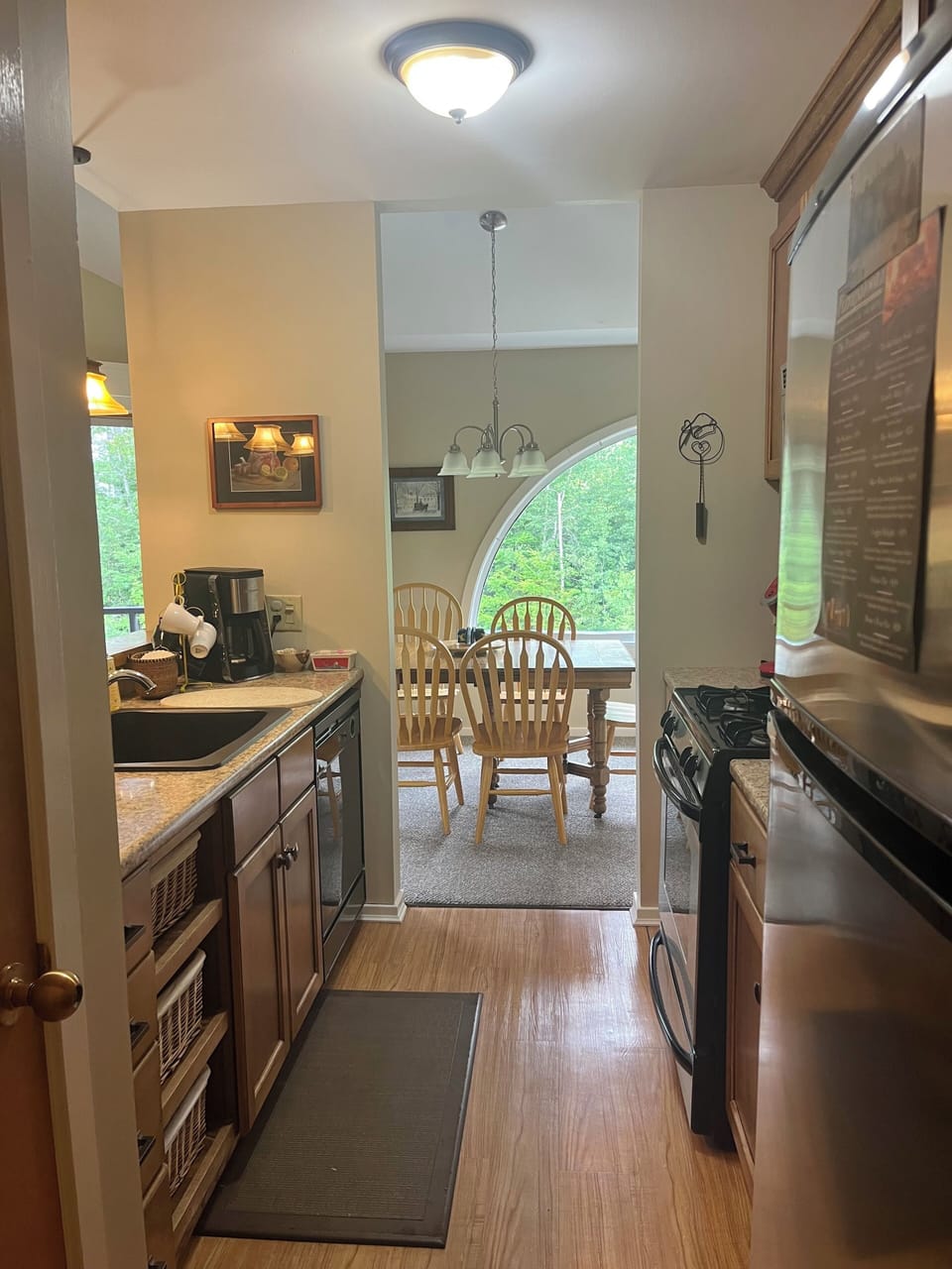 View of galley kitchen and dining room. 