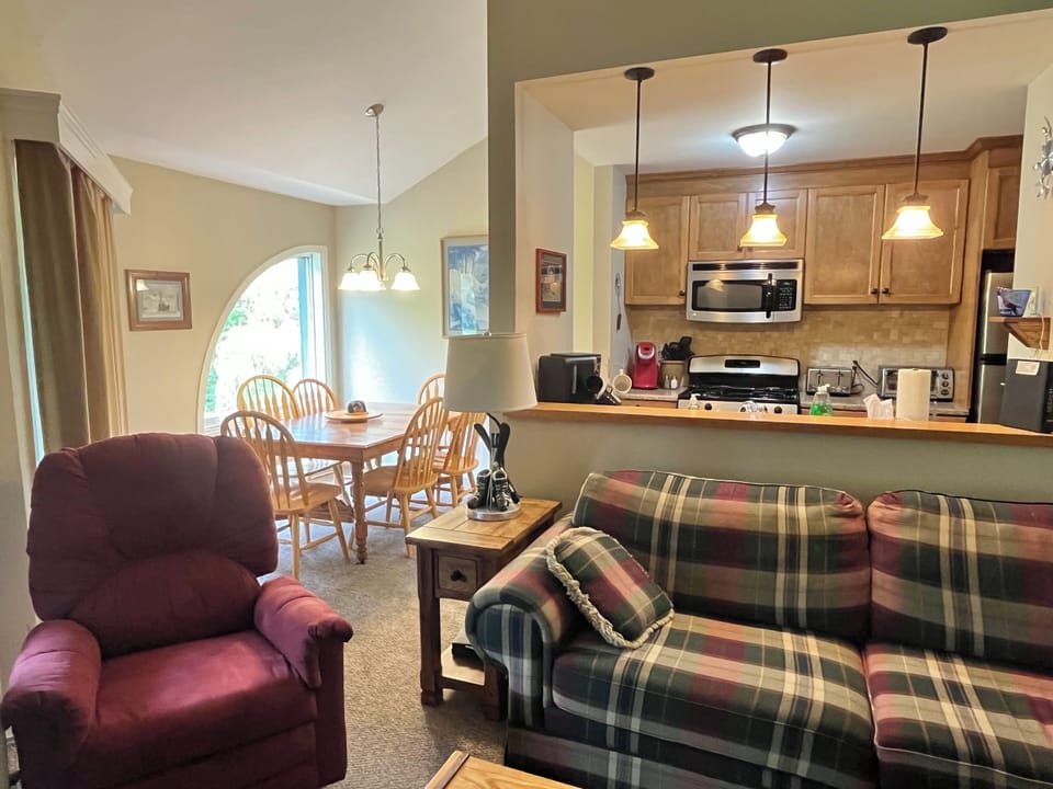 View of dining room and kitchen from fireplace area.