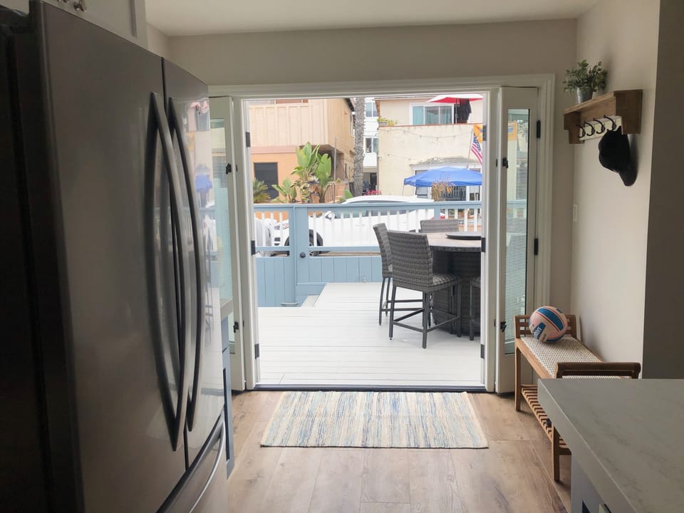 Coat rack and bench for storing shoes.  French door to open to the deck.  