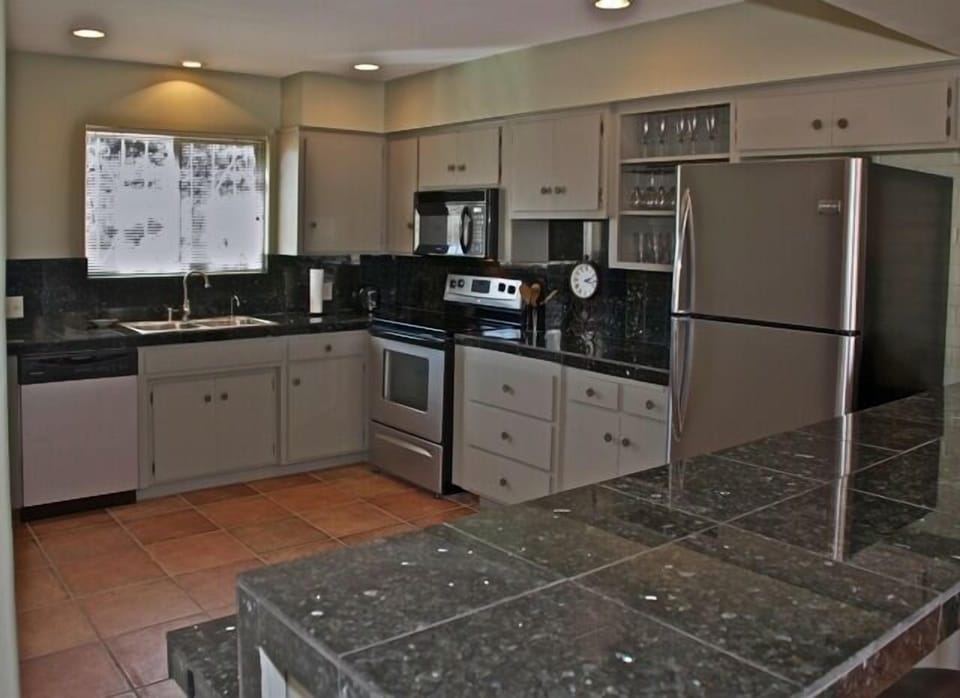 Updated kitchen has new appliances, plenty of cookware, &  granite countertops.