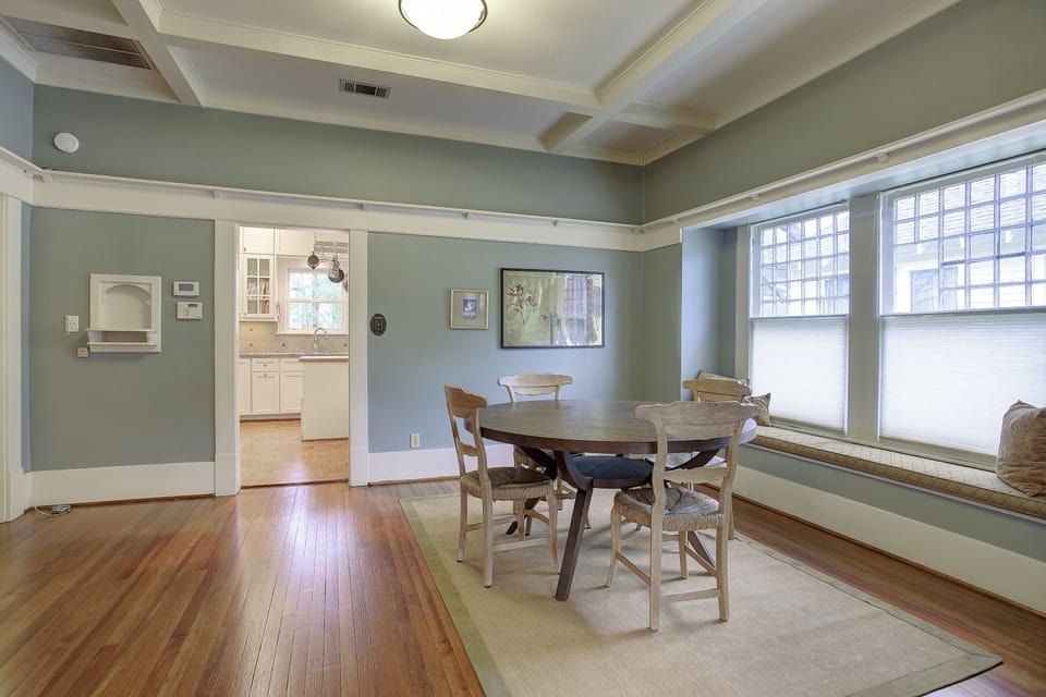 Dining room with large round West Elm table. Built in bench.