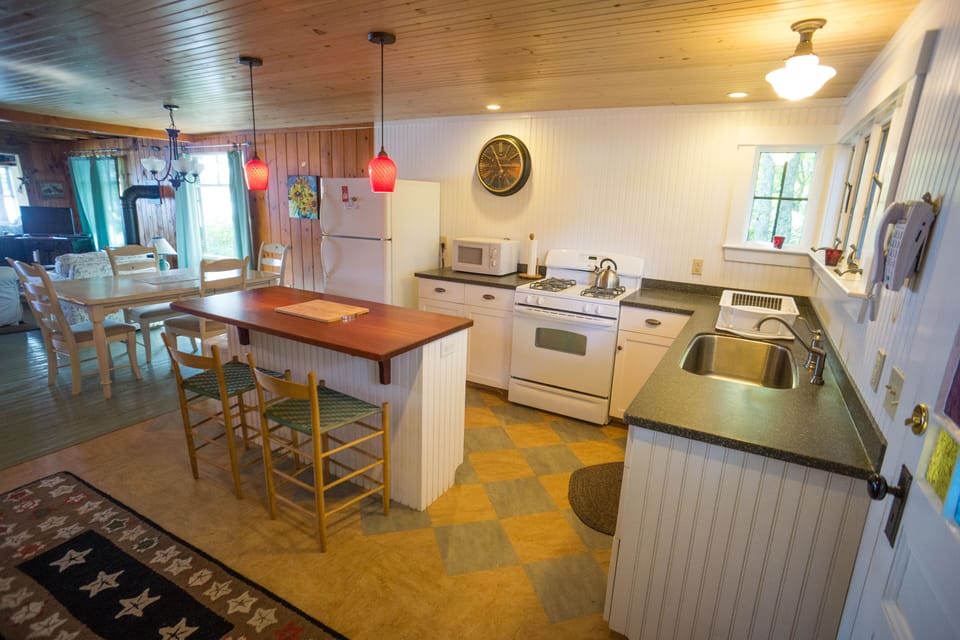 The kitchen has a gas stove, oven, and cherry center island.