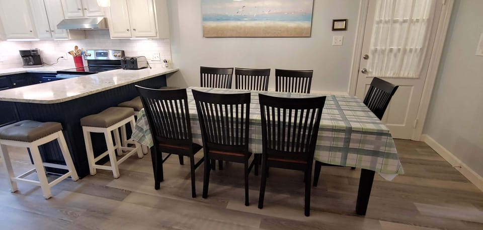 Table seats 8-12, with additional counter seating with 4 bar stools.  