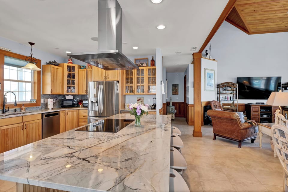 Island with cooktop and oven.