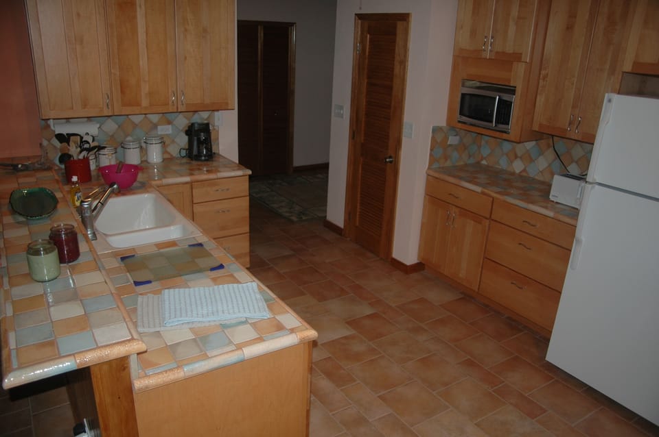 Kitchen outfitted for family cooking and close to great room for hanging out