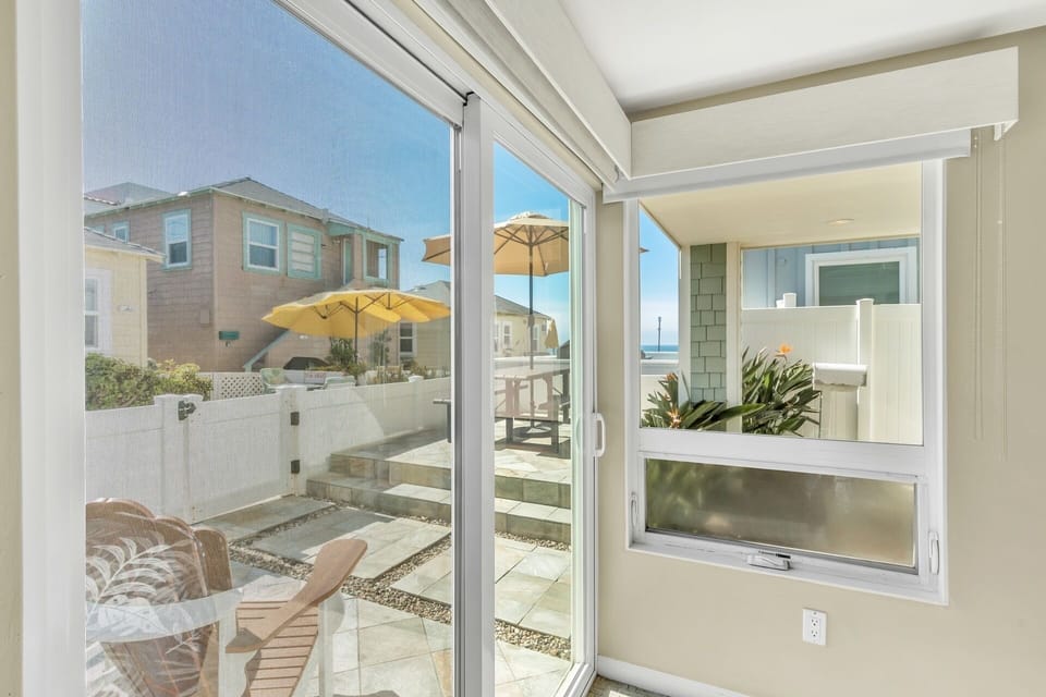 Ground floor: Bedroom's patio door opens to furnished patio with lounge chairs and table