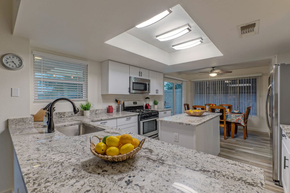 Updated kitchen looks flashy with new cabinets and counter tops.