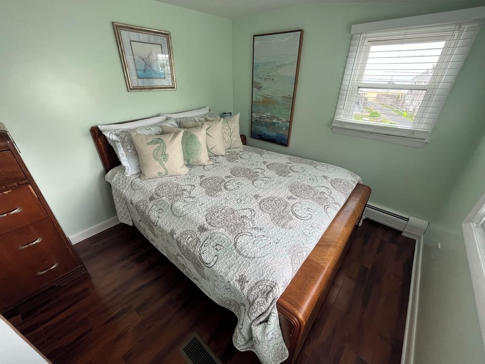 Second floor bedroom w/ full bed, bay window and views of ocean and roof deck. 